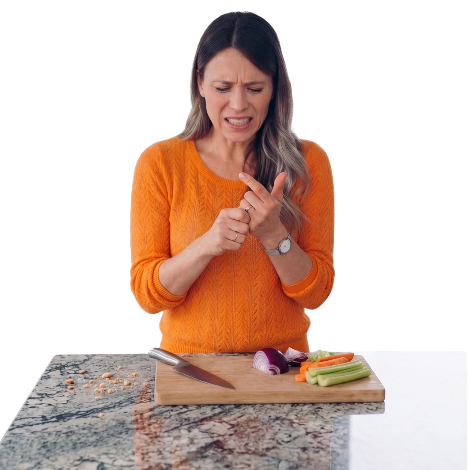 Woman in an orange sweater wincing at a nicked finger