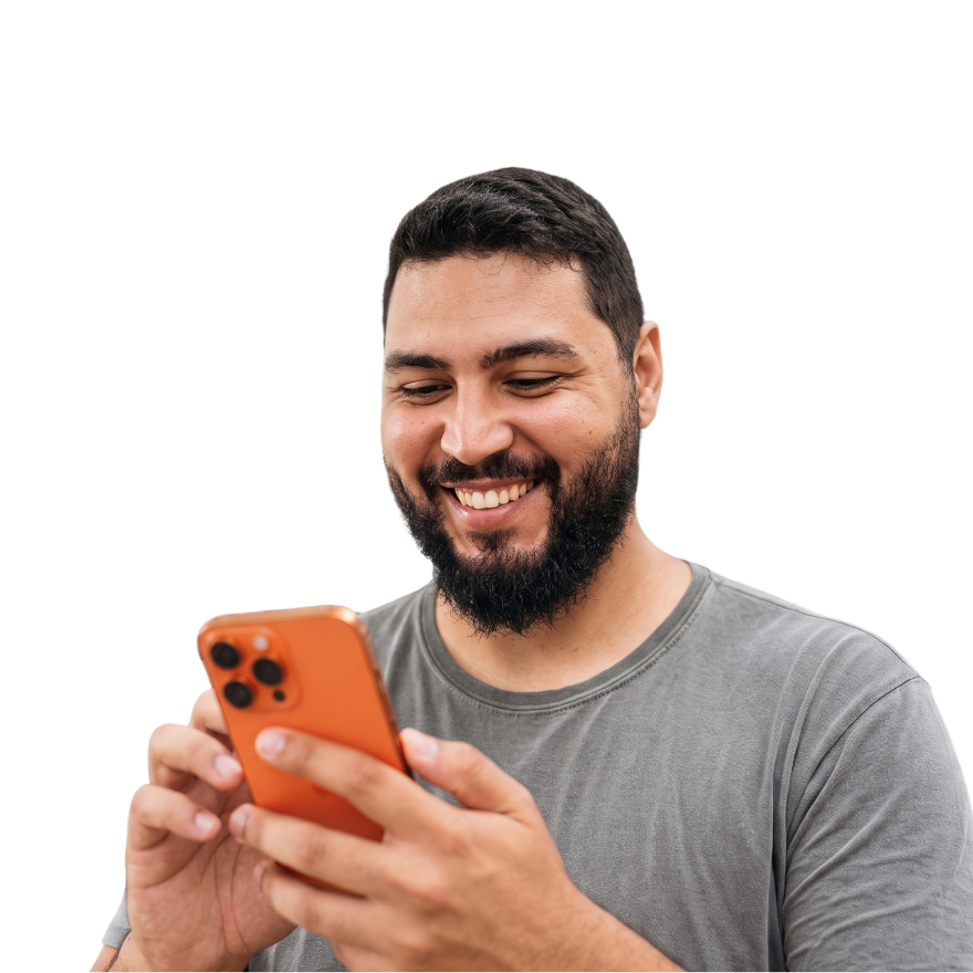 Smiling man with a beard checking his phone